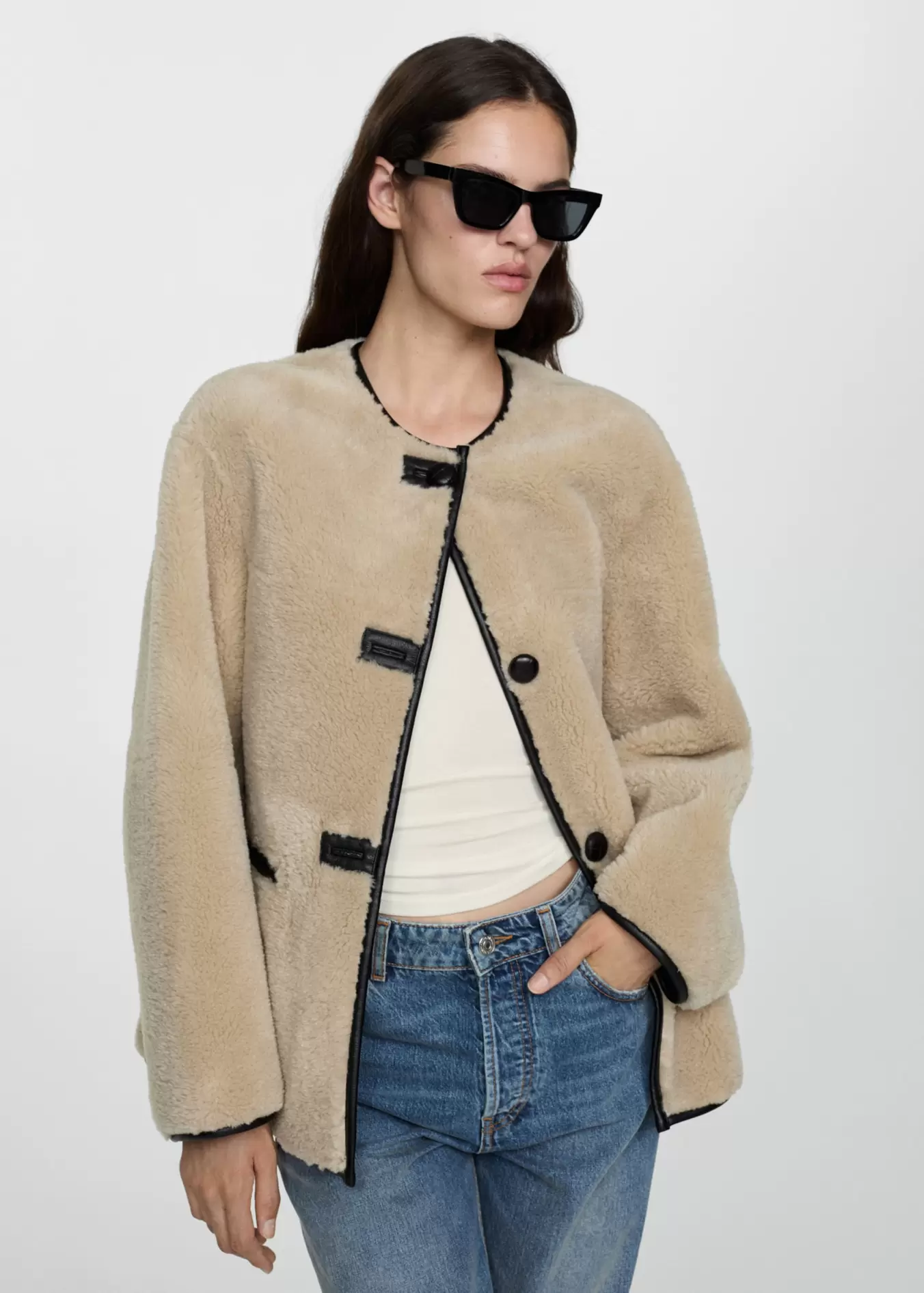 Fur-effect coat with appliqués offers at $119.99 in Mango